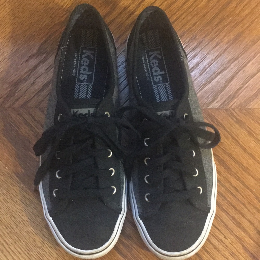 A pair of black Keds.